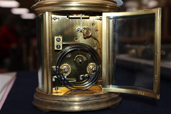 An Edwardian oval brass carriage clock, with travelling case height 13cm